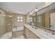 Luxurious bathroom featuring a glass-enclosed shower, a soaking tub, and dual vanities at 1117 Shipwatch Cir, Tampa, FL 33602
