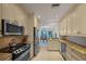 Efficient kitchen design with stainless steel appliances and a view into the bright dining room at 1117 Shipwatch Cir, Tampa, FL 33602