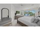 This main bedroom offers a view of lush palm trees and tranquil waterfront at 1117 Shipwatch Cir, Tampa, FL 33602