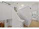 Hallway with staircase featuring white walls and contrasting tan flooring at 1117 Shipwatch Cir, Tampa, FL 33602