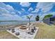 Backyard firepit area with seating, overlooking a serene lake at 11427 Laurel Brook Ct, Riverview, FL 33569