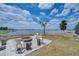 Backyard firepit area with seating, overlooking a serene lake at 11427 Laurel Brook Ct, Riverview, FL 33569