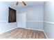 Light blue bedroom with ceiling fan, wood floors, and a closet at 11427 Laurel Brook Ct, Riverview, FL 33569