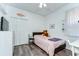 Cozy bedroom with light gray floors, ceiling fan, and closet at 11427 Laurel Brook Ct, Riverview, FL 33569