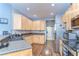Modern kitchen with stainless steel appliances, ample cabinetry, and a breakfast bar area at 11427 Laurel Brook Ct, Riverview, FL 33569