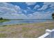 Scenic lake view with clear blue water and a natural shoreline, providing a tranquil setting at 11427 Laurel Brook Ct, Riverview, FL 33569