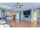 Large living room flows into the kitchen, and has wood floors plus modern lighting fixtures at 11427 Laurel Brook Ct, Riverview, FL 33569