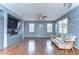 Comfortable living room with built-in entertainment center, wood floors, ceiling fan and natural light at 11427 Laurel Brook Ct, Riverview, FL 33569