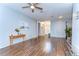 Bright living room features beautiful wood floors, neutral paint, and a ceiling fan for added comfort at 11427 Laurel Brook Ct, Riverview, FL 33569