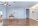 Open-concept living room with warm wood floors, soft blue walls and ample natural light at 11427 Laurel Brook Ct, Riverview, FL 33569