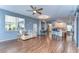 Spacious living room with an open layout, connecting to the kitchen, and featuring wood floors at 11427 Laurel Brook Ct, Riverview, FL 33569