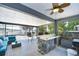 Inviting screened patio with a wet bar, seating area, and views of the pool at 11427 Laurel Brook Ct, Riverview, FL 33569