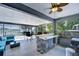 Inviting screened patio with a wet bar, seating area, and views of the pool at 11427 Laurel Brook Ct, Riverview, FL 33569