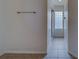 Hallway leading to the bathroom featuring a glass block window at 11546 Leisure W Ln, Largo, FL 33773