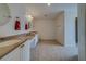 Spacious bathroom boasts dual sinks, white cabinets, neutral tile flooring, and a stand-up shower at 11546 Leisure W Ln, Largo, FL 33773