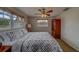 Comfortable bedroom featuring carpet, a ceiling fan, and plenty of natural light from two large windows at 11546 Leisure W Ln, Largo, FL 33773