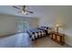 Bright bedroom featuring tile flooring, a cozy bed, wooden furniture, and double doors leading to the backyard at 11546 Leisure W Ln, Largo, FL 33773