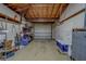 Spacious garage interior with exposed wood ceiling, concrete walls, and ample storage for vehicles and equipment at 11546 Leisure W Ln, Largo, FL 33773