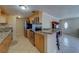 Well-lit kitchen features stainless steel appliances, tile flooring, and wooden cabinetry at 11546 Leisure W Ln, Largo, FL 33773