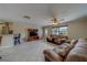 Cozy living room features tile flooring, a ceiling fan, and plenty of natural light at 11546 Leisure W Ln, Largo, FL 33773