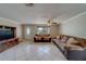 Spacious living room features tile flooring, ceiling fan, and ample seating at 11546 Leisure W Ln, Largo, FL 33773