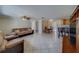 Open concept living space with dining area and kitchen features tile flooring and a ceiling fan at 11546 Leisure W Ln, Largo, FL 33773