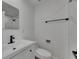 Bright bathroom features a modern vanity, toilet, and sleek black fixtures at 1208 E 18Th Ave, Tampa, FL 33605