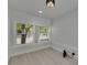 Inviting bedroom features bright windows overlooking neighborhood, contemporary lighting, and neutral flooring at 1208 E 18Th Ave, Tampa, FL 33605