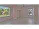 Bright bedroom with two windows, light pink walls, and new floors at 1208 E 18Th Ave, Tampa, FL 33605
