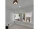 Bright bedroom features large windows with blinds, contemporary lighting, and neutral flooring at 1208 E 18Th Ave, Tampa, FL 33605