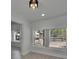 Comfortable bedroom features bright windows overlooking neighborhood, modern lighting, and neutral flooring at 1208 E 18Th Ave, Tampa, FL 33605