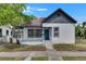 Charming home with a inviting front porch, complemented by a blue front door at 1208 E 18Th Ave, Tampa, FL 33605