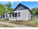 Charming home featuring white stucco, a dark gray roof, and a welcoming front porch at 1208 E 18Th Ave, Tampa, FL 33605