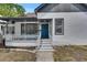 Charming home featuring a beautiful blue front door, complemented by a cozy front porch at 1208 E 18Th Ave, Tampa, FL 33605