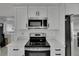 Stainless steel microwave and stove with white cabinets and countertop at 1208 E 18Th Ave, Tampa, FL 33605