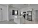 Bright kitchen with stainless steel appliances, island with white countertop, and modern cabinetry at 1208 E 18Th Ave, Tampa, FL 33605