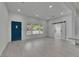Spacious open-concept living space with sleek flooring, natural light, and modern barn door feature at 1208 E 18Th Ave, Tampa, FL 33605