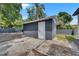 View of detached structure in backyard with gravel landscaping and partial fencing at 1208 E 18Th Ave, Tampa, FL 33605