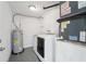 Laundry room features a water heater, washer, and dryer at 12221 Saddle Strap Row, Hudson, FL 34667