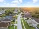 Scenic aerial view of a residential neighborhood with tree-lined streets under a bright sky with a hint of sunset at 12531 Blazing Star Dr, Tampa, FL 33626