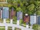 An aerial shot showcases a home with a gray roof amidst lush greenery and neighboring residences at 12531 Blazing Star Dr, Tampa, FL 33626
