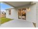 Covered back patio with sliding glass doors offers seamless indoor-outdoor living and entertaining options at 12531 Blazing Star Dr, Tampa, FL 33626