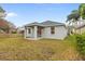 This backyard offers a covered patio, and ample space for various outdoor activities at 12531 Blazing Star Dr, Tampa, FL 33626