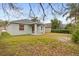 Backyard featuring a covered patio with an expansive lawn, providing a serene and private outdoor space at 12531 Blazing Star Dr, Tampa, FL 33626