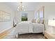 Bright bedroom features neutral decor, large window, and decorative lighting at 12531 Blazing Star Dr, Tampa, FL 33626