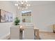 Bright dining area with modern chandelier and a large window, adjacent to an art piece at 12531 Blazing Star Dr, Tampa, FL 33626
