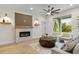 Bright living room featuring a modern fireplace and access to the outdoors at 12531 Blazing Star Dr, Tampa, FL 33626