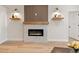 Modern living room featuring an electric fireplace with stylish wood and marble accents at 12531 Blazing Star Dr, Tampa, FL 33626