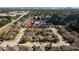 Aerial shot of a residential neighborhood showcasing lush greenery and well-maintained homes near a waterfront at 13135 Plantation Ter, Seminole, FL 33776
