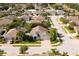 Aerial view featuring home with paver driveway, lush landscaping, and community streetscapes at 13135 Plantation Ter, Seminole, FL 33776